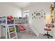 Fun room with a unique loft bed featuring a slide and ladder, complemented by playful wall decor at 12374 Farmview St, Thornton, CO 80241