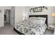 Charming bedroom with a decorated bed, complemented by tasteful wall decor and an inviting open doorway at 12374 Farmview St, Thornton, CO 80241