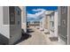 View down driveway to garages showing the community's modern architectural style at 12374 Farmview St, Thornton, CO 80241