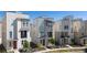 Modern townhome row with varied neutral exteriors, landscaping and inviting curb appeal at 12374 Farmview St, Thornton, CO 80241