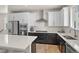 A stunning kitchen has white cabinets, stainless steel appliances, and quartz countertops at 12374 Farmview St, Thornton, CO 80241