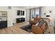 Bright living space featuring a comfy sofa, modern furnishings, and a mounted TV at 12374 Farmview St, Thornton, CO 80241