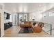 Inviting living room showcasing a leather sectional and modern accents at 12374 Farmview St, Thornton, CO 80241