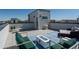 Open rooftop terrace with a fire pit, lounge chairs, and neighborhood views with blue sky at 12374 Farmview St, Thornton, CO 80241