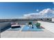 Expansive rooftop deck featuring a modern fire pit, comfortable seating, and panoramic neighborhood views under a sunny sky at 12374 Farmview St, Thornton, CO 80241