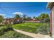 Lush backyard with a well-maintained lawn, outbuilding, and mature landscaping at 2361 Olive St, Denver, CO 80207