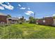Expansive backyard with lush greenery, outbuildings, and ample space for outdoor activities at 2361 Olive St, Denver, CO 80207