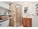 Bathroom with a shower, shelves, and sink with cabinet at 2361 Olive St, Denver, CO 80207