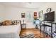 Bright bedroom with hardwood floors, a bed, and decorations on the wall at 2361 Olive St, Denver, CO 80207