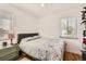 Cozy bedroom featuring hardwood floors, a comfortable bed and a bright window with natural light at 2361 Olive St, Denver, CO 80207