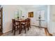 Cozy dining room with hardwood flooring, a classic wooden table set, and natural light from the window at 2361 Olive St, Denver, CO 80207