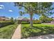 Lovely single-story home with lush green lawn and mature shade tree creating a peaceful setting at 2361 Olive St, Denver, CO 80207