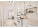 A brightly lit kitchen with white appliances and marble countertops at 2361 Olive St, Denver, CO 80207