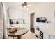 Bright eat-in kitchen with white cabinetry, granite counters, and a glass table at 2361 Olive St, Denver, CO 80207