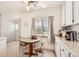Sunlit breakfast nook with white cabinets, granite counters, and a ceiling fan at 2361 Olive St, Denver, CO 80207