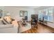 Cozy living room featuring hardwood floors, stylish furniture, and a large window for natural light at 2361 Olive St, Denver, CO 80207