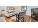 Bright living room with hardwood floors, neutral sofa, area rug, and modern decor accents at 2361 Olive St, Denver, CO 80207