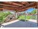 Covered outdoor patio with a brick fireplace, offering a cozy spot for relaxation and entertaining at 2361 Olive St, Denver, CO 80207