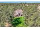 Aerial view of a beautiful property nestled among tall trees, showcasing a well-manicured lawn and inviting outdoor spaces at 38666 County Road 21, Elizabeth, CO 80107