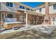 A backyard oasis with a hot tub, an outdoor kitchen under a covered patio, and a brick fireplace at 38666 County Road 21, Elizabeth, CO 80107