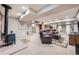 Spacious basement with a vintage wood-burning stove, carpet floors, and a leather sofa set at 38666 County Road 21, Elizabeth, CO 80107