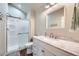Well-lit bathroom featuring a shower with glass doors, white vanity, and modern fixtures for a clean and stylish look at 38666 County Road 21, Elizabeth, CO 80107