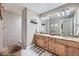 Bathroom with a double vanity with granite countertop, tiled floors, and walk-in shower at 38666 County Road 21, Elizabeth, CO 80107