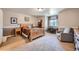 Comfortable bedroom with plush carpeting, half-painted walls, and natural wood furniture and light at 38666 County Road 21, Elizabeth, CO 80107