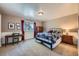 Well-lit bedroom with a desk, nightstand, and a comfortable bed with a patterned comforter at 38666 County Road 21, Elizabeth, CO 80107