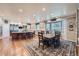 Bright kitchen featuring an island, wooden floors, stainless appliances, and an eat-in dining area at 38666 County Road 21, Elizabeth, CO 80107