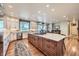 Open kitchen with center island, bright lighting, modern appliances, and wood floors creating a warm space at 38666 County Road 21, Elizabeth, CO 80107