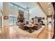 Spacious living room with a floor-to-ceiling stone fireplace, hardwood floors and large windows at 38666 County Road 21, Elizabeth, CO 80107