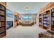 Elegant living room featuring a fireplace, built-in bookshelves, and comfortable seating at 38666 County Road 21, Elizabeth, CO 80107