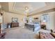 Spacious bedroom with a trey ceiling, ceiling fan, and windows providing natural light at 38666 County Road 21, Elizabeth, CO 80107