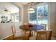 Bright dining nook with a round table and chairs, adjacent to a patio door at 9835 Keenan St, Highlands Ranch, CO 80130