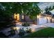 Inviting home exterior with a walkway illuminated by landscape lighting leading to the front entrance at 9835 Keenan St, Highlands Ranch, CO 80130