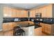 Kitchen featuring wooden cabinets, granite countertops and a tiled backsplash at 9835 Keenan St, Highlands Ranch, CO 80130