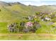 Scenic aerial perspective showcasing a grand estate with mature trees and verdant surroundings at 6634 Window Rock Ln, Morrison, CO 80465