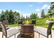 Backyard fire pit with seating in a lush green setting at 6634 Window Rock Ln, Morrison, CO 80465