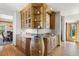 Unique bar area featuring a converted barrel sink, granite countertops, and custom wooden cabinetry at 6634 Window Rock Ln, Morrison, CO 80465