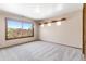 Bright bedroom with large window and shelf showing peaceful views of outdoor scenery at 6634 Window Rock Ln, Morrison, CO 80465