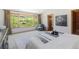 Serene bedroom featuring a scenic view, plush carpet, and natural light at 6634 Window Rock Ln, Morrison, CO 80465