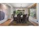 Elegant dining room with large windows, modern lighting fixture, and plush upholstered chairs at 6634 Window Rock Ln, Morrison, CO 80465