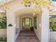 Welcoming entryway with custom wood door, stone flooring, and decorative sconces at 6634 Window Rock Ln, Morrison, CO 80465