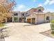 Elegant two-story home with three-car garage and arched windows and mature trees at 6634 Window Rock Ln, Morrison, CO 80465
