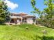 Large home exterior featuring lush backyard, an outdoor grilling area, and extensive views at 6634 Window Rock Ln, Morrison, CO 80465