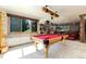 Spacious game room with a pool table and a large screen showing outdoor scenery at 6634 Window Rock Ln, Morrison, CO 80465