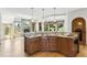 Kitchen featuring granite countertops, custom cabinets, and wood floors leading to living room at 6634 Window Rock Ln, Morrison, CO 80465