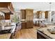 Spacious kitchen with custom cabinets, granite countertops, stainless steel appliances, and hardwood floors at 6634 Window Rock Ln, Morrison, CO 80465