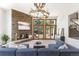 Cozy living room with stone fireplace, large windows offering natural light, and comfortable seating at 6634 Window Rock Ln, Morrison, CO 80465